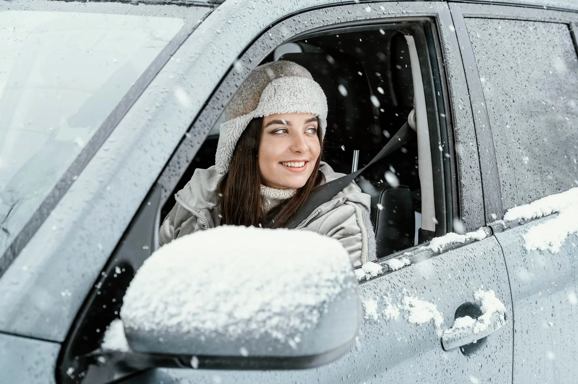 side view of smiley woman driving the car for on a road trip